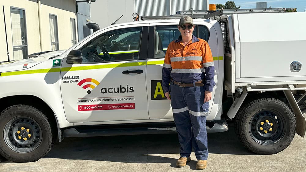 Holly Pluss standing in front of Acubis service vehicle