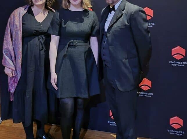 Three professionals at Emergent Group recognition event in Australia.